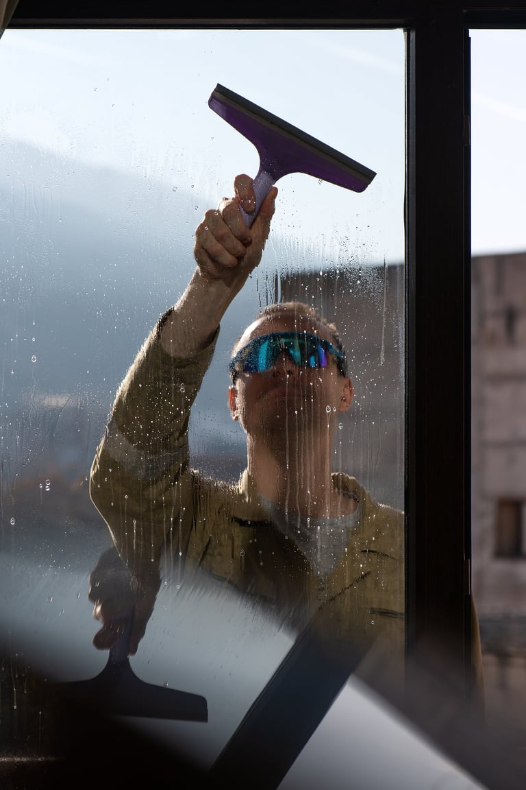 Professional window cleaner at work